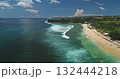 Stunning aerial view of Dreamland Beach in Bali, Indonesia, featuring vibrant turquoise waters, gentle waves on white sand, and lush green cliffs under a bright blue sky Stunning aerial view of Dreamland Beach in Bali, Indonesia, featuring vibrant turquoise waters, gentle waves on white sand, and lush green cliffs under a bright blue sky 132444218