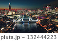 UK, London: Aerial view of famous Tower Bridge at night, The Shard and other landmarks along the Thames River, creating a stunning urban cityscape in colorful evening lights. Drone flight panorama UK, London: Aerial view of famous Tower Bridge at night, The Shard and other landmarks along the Thames River, creating a stunning urban cityscape in colorful evening lights. Drone flight panorama 132444223