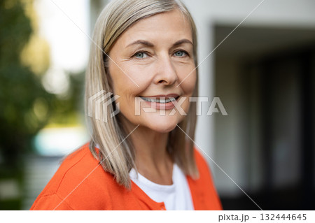 Portrait picture of a mature blonde woman feeling good and positive Portrait picture of a mature blonde woman feeling good and positive 132444645