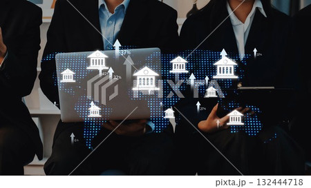 Business professionals using technology and analyzing global financial data with digital graphics of banks and world map in a modern office setting. Raster Business professionals using technology and analyzing global financial data with digital graphics of banks and world map in a modern office setting. Raster 132444718