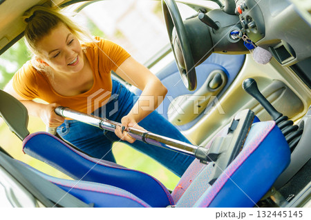 Cleaning car interior with vacuum cleaner Cleaning car interior with vacuum cleaner 132445145