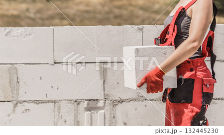 Woman working with bricks 132445230