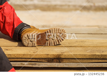 Person wearing red worker trousers 132445236