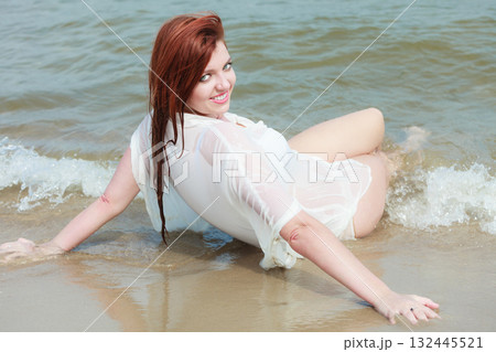 Sensual girl wet cloth in water on the coast. 132445521