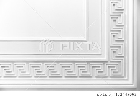 Meander motif over white wall backdrop. Classic moulding pattern, 132445663
