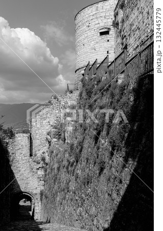 Monochrome image of Brescia Castle shows Torre Coltrina and Strada del Soccorso in stone detail 132445779