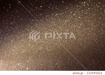Glittering golden brown surface with diagonal illumination from lower left reveals rich texture Glittering golden brown surface with diagonal illumination from lower left reveals rich texture 132445822