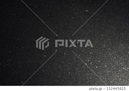 Black glitter texture with countless sparkles glowing from lower right and fading into darkness Black glitter texture with countless sparkles glowing from lower right and fading into darkness 132445825
