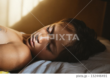 Sleeping Child Bathed in Sunlight 132446491
