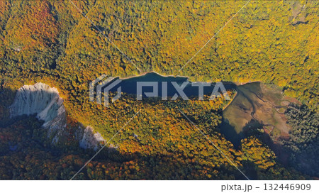 Biogradsko lake surrounded by mountains covered with bright autumn trees Biogradsko lake surrounded by mountains covered with bright autumn trees 132446909