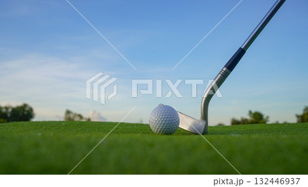 Golf clubs and balls on a green lawn in a beautiful golf course with morning sunshine. 132446937