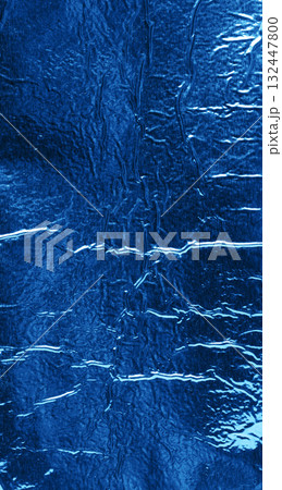 exture of shiny blue foil with numerous wrinkles and folds. Close up 132447800