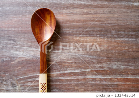 wood spoon on wooden board 132448314