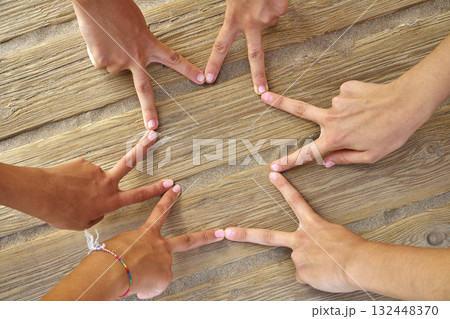 Star shape with six hand fingers on a beach Star shape with six hand fingers on a beach 132448370