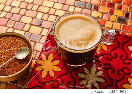 Coffee glass cup with cream on tiles red table Coffee glass cup with cream on tiles red table 132449084