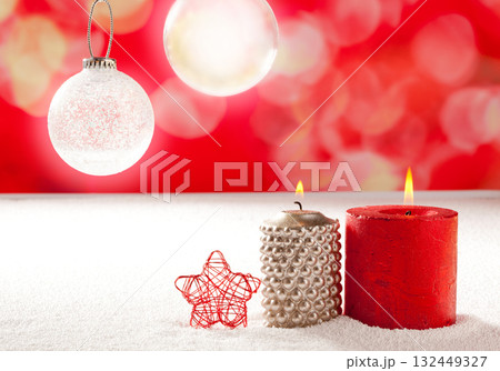 christmas silver red candles and star on snow 132449327