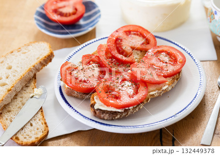 two bruschettas with tomato slices on a plate 132449378