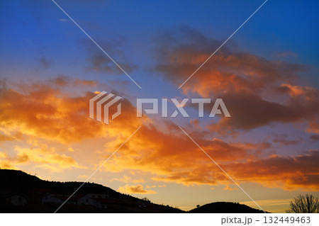 Sunset mountain silhouette with orange clouds 132449463