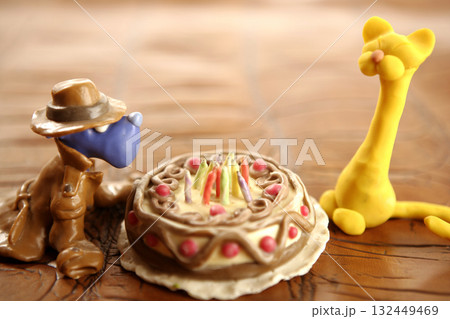 Toy plasticine happy birthday cake over white 132449469