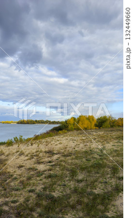An autumn river landscape with yellow leaves on the trees, reflections 132449660