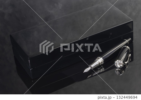 A signature fountain pen on a gray marble background. A box and case are nearby. 132449694