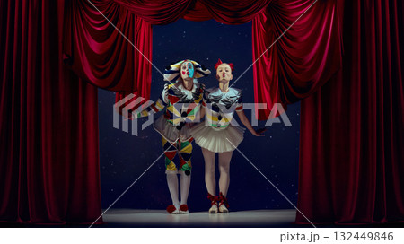 Behind the curtain. Mime and ballerina posing with kiss lips under spotlight. 132449846