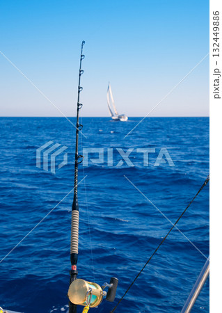 fishing boat trolling in ocean with golden reel fishing boat trolling in ocean with golden reel 132449886