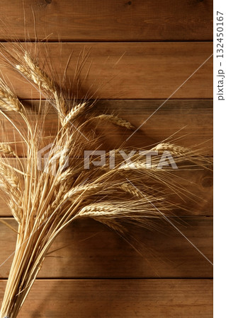 Ear golden wheat spike over wooden background 132450167