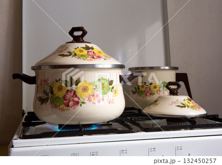 Retro vintage kitchen with pots pans of porcelain 132450257