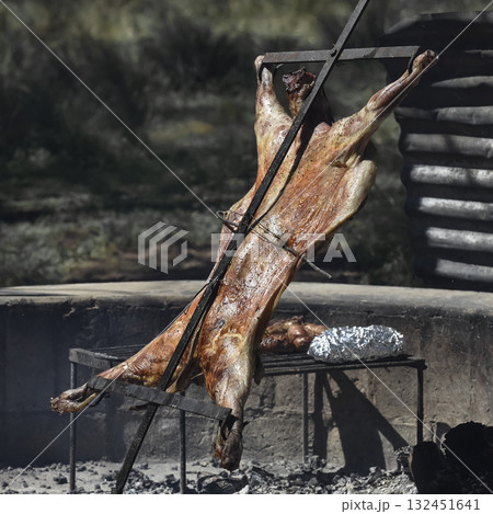 Lamb on the spit, cooked with the traditional Argentine method, La Pampa province, Patagonia, Argentina. 132451641