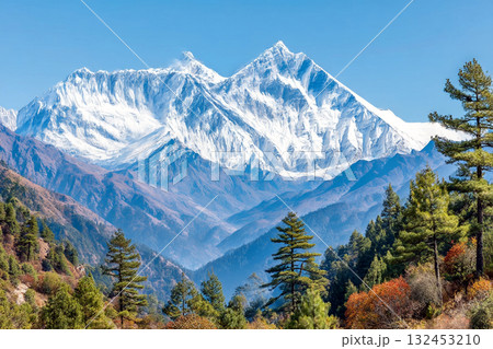 Majestic Snowy Mountain Landscape with Pine Forest under Clear Blue Sky for Nature Lovers and Adventurers Majestic Snowy Mountain Landscape with Pine Forest under Clear Blue Sky for Nature Lovers and Adventurers 132453210