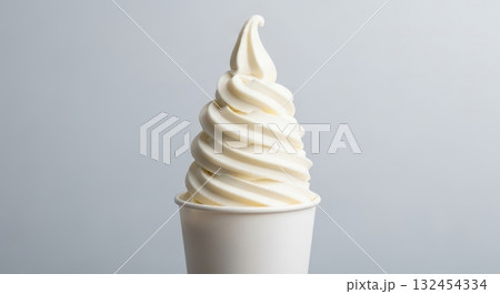 Vanilla soft serve ice cream in white cup against minimalistic background Vanilla soft serve ice cream in white cup against minimalistic background 132454334