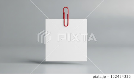 Minimalist red paperclip holding blank white paper against neutral background Minimalist red paperclip holding blank white paper against neutral background 132454336