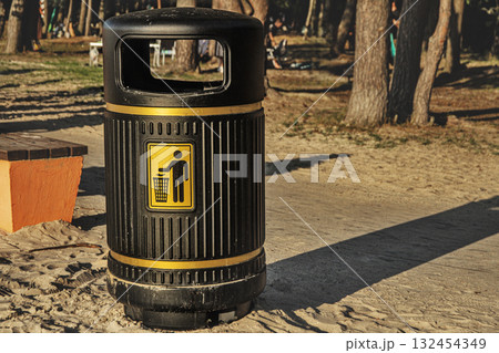 Black and Gold Trash Can in Park 132454349