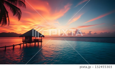 Sunset on a tropical beach with pier and ocean view at dusk. 132455303