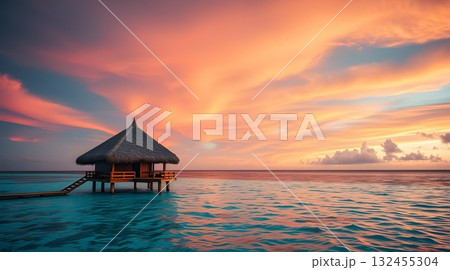Sunset on a tropical beach with pier and ocean view at dusk. 132455304