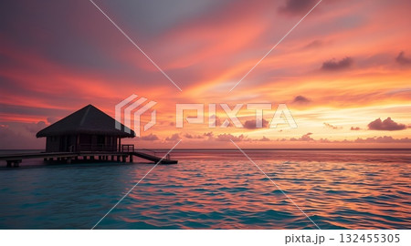 Sunset on a tropical beach with pier and ocean view at dusk. 132455305