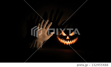 Minimalist Ghost Hands with Pumpkin Casting a Large Menacing Shadow Minimalist Ghost Hands with Pumpkin Casting a Large Menacing Shadow 132455488