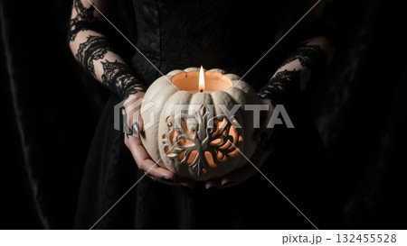 Elegant Hands in Black Lace Holding White Victorian Jack-o-Lantern 132455528