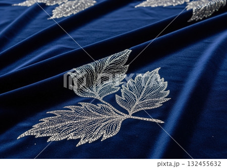 Luxurious midnight blue velvet fabric with shimmering silver leaf embroidery 132455632