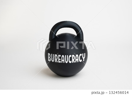 A heavy weight labeled "bureaucracy." Processes are slowed down, work is inefficient, and regulation is overloaded. Pressure on business. Complex tax system. Administrative and government inefficiency 132456014