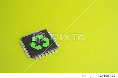 A chip with a recycling symbol. Concept of eco-friendly technology and digital sustainability. Green innovation, circular economy, and electronic waste reduction. 132456133