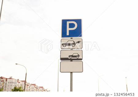 Electric vehicle parking sign with charging station in urban area 132456453