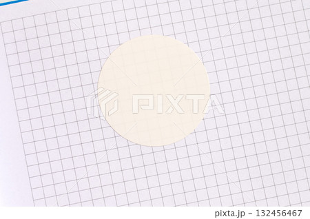 Blank circle sticker on graph paper with gridded background for design and craft use 132456467
