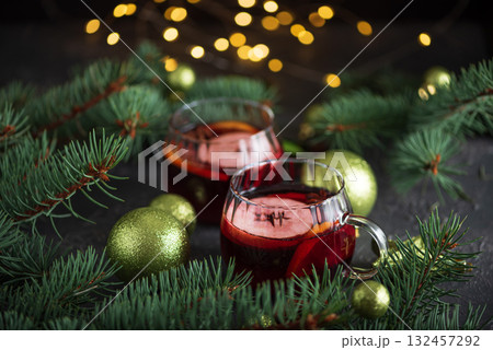 Two Glass Mugs of Mulled Wine with Christmas Decor and Fairy Lights Two Glass Mugs of Mulled Wine with Christmas Decor and Fairy Lights 132457292