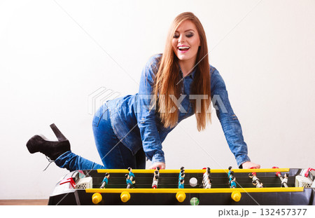 woman playing table football game woman playing table football game 132457377