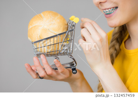 Woman holding shopping cart with bread 132457459