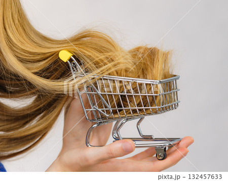 Girl with her long hair in shopping cart 132457633