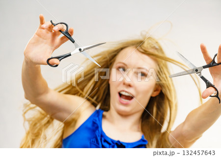 Girl with scissors for haircutting Girl with scissors for haircutting 132457643