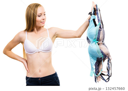Woman holds bras, choosing Woman holds bras, choosing 132457660